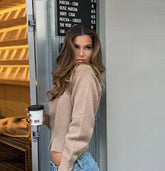 Woman holding a coffee cup in a casual setting